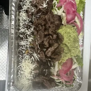 a tray of meat and vegetables