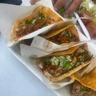 a plate of tacos with meat and vegetables
