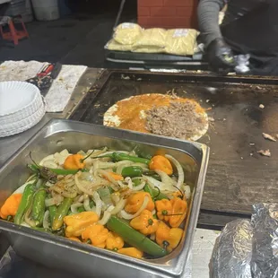 Preparation of a suadero quesadilla.