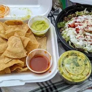 Homemade tortilla chips, hot sauces, carne asada burrito bowl, and guac - it&apos;s all amazing!