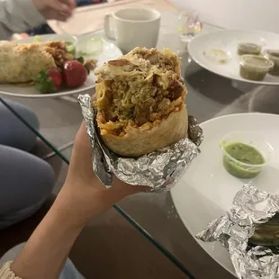 a person holding a burrito