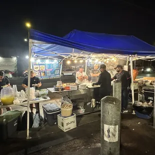 a group of people at a food stand