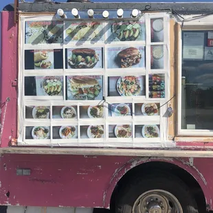 a food truck with menus on the side