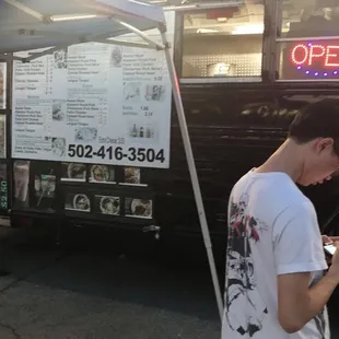 a man standing in front of a food truck