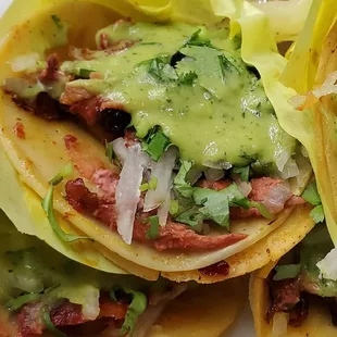 Pastor tacos with guacamole.