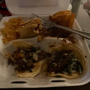 Two asada tacos and a red tamale W beans and rice