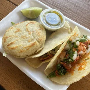 a plate of tacos and salsa