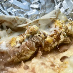 Chorizo, bacon, bean, egg, and cheese tacos.