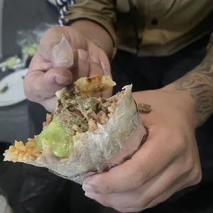 a man holding a burrito