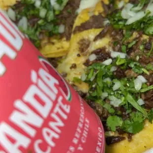 a can of guacamole next to a plate of tacos
