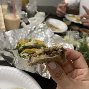 a person holding a piece of food