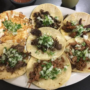 a plate of tacos with shredded beef