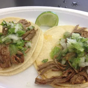 two tacoss on a plate