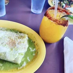 Wet burrito with green sauce and a mango margarita.