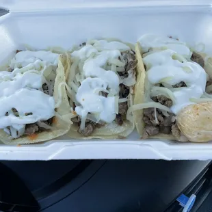 Asada tacos with cheese and sour cream