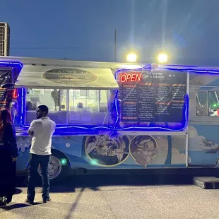 a man standing in front of a food truck