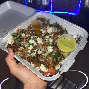 Sopes de carne asada, beans, salsa de chile de árbol, salsa de chile jalapeño, onion, cilantro, tomatoes, onion, queso fresco