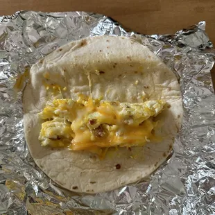 a breakfast burrito wrapped in foil