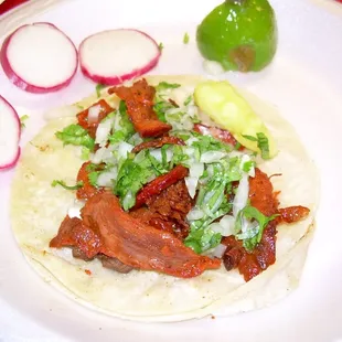 a taco with meat and vegetables