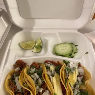 2 chorizo tacos on the left, 2 pastor tacos (with pineapple) on the right