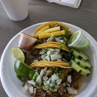 a plate of tacos and a drink