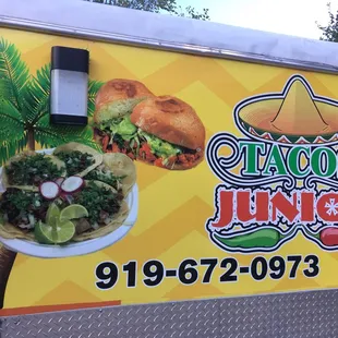 a taco truck with a taco and salad on the side