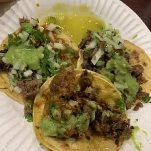 two tacos on a paper plate
