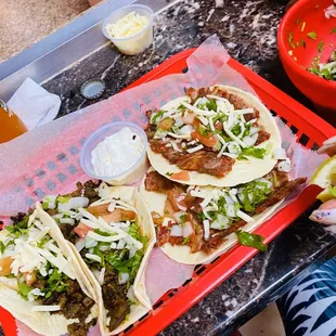 three tacoss on a tray