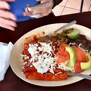 Enchiladas with fresh avocado  and 2 or one big piece of meat to perfection