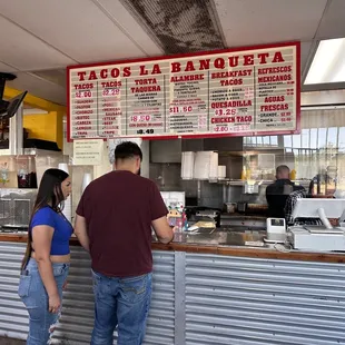 a man and a woman ordering food
