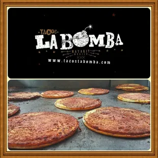 pizzas cooking on a grill