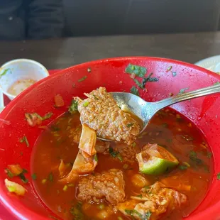 a red bowl of mexican food