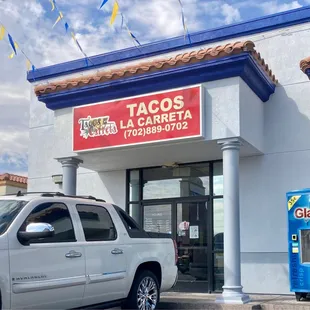 a car parked in front of a taco shop