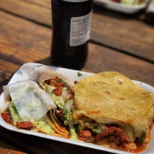 a plate of food and a bottle of coke