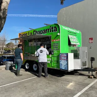 two people ordering food from a food truck