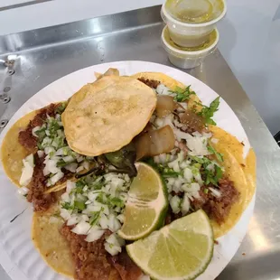 4 tacos de tripa,  onions, cilantro,  nopales, caramelized onions,  a tostada , and salsa verde, $7