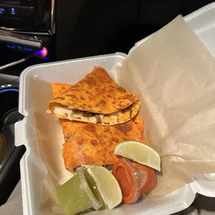 Birria quesadilla with a lime &amp; mild/hot sauce on the side.