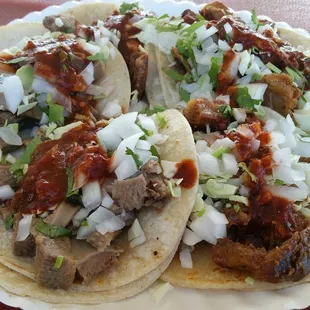 5 tacos with everything on top. That red salsa is real good. 3 tripas and 2 lengua.