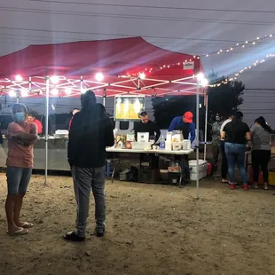 people standing under a tent