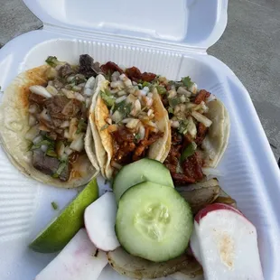 a plate of tacos and a cucumber