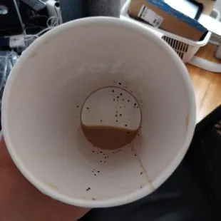 a person holding a coffee cup