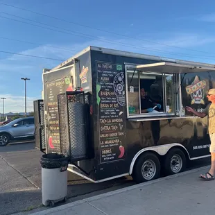 a man ordering food from a food truck