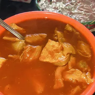 Big bowl of menudo with handmade tortillas