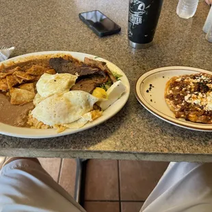 Chilaquiles con Bistek and eggs and beans. The other one on the right is the famous picadita with chorizo