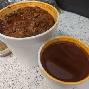 1 lb of birria. Meat packed in one container with extra consomé on the side