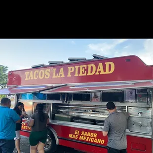people ordering food from a food truck