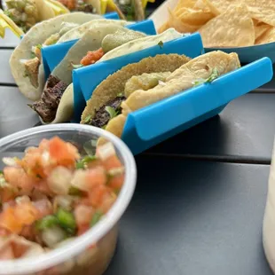 Al pastor, chicken, and portobello mushroom tacos with chips and guac and chips and salsa. With horchata.
