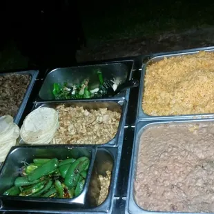 Steam table with the taco meats rice and beans!