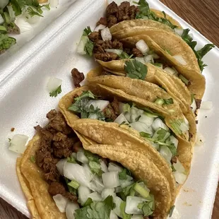 three tacoss in a styrofoam container