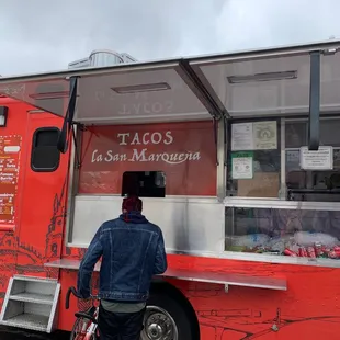 a man standing in front of a food truck